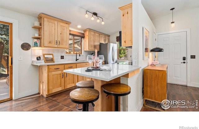 1922 Enfield Ct, Fort Collins, CO 80526 - kitchen featuring freestanding refrigerator, light brown cabinetry, dark wood-type flooring, and vaulted ceiling