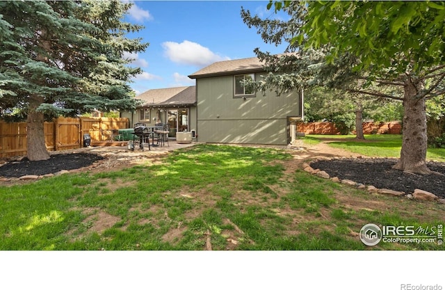 1922 Enfield Ct, Fort Collins, CO 80526 - rear view of house featuring a patio and a fenced backyard