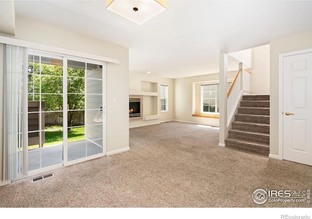 2120 Timber Creek Dr Unit 5, Fort Collins, CO 80528 - unfurnished living room with carpet flooring, stairs, and a tile fireplace