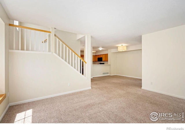2120 Timber Creek Dr Unit 5, Fort Collins, CO 80528 - unfurnished living room with carpet flooring and stairs