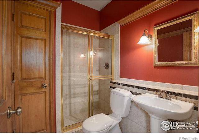 14448 Hanover St, Brighton, CO 80602 - full bath with a shower stall, tile walls, and a wainscoted wall