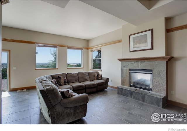 14448 Hanover St, Brighton, CO 80602 - tiled living area featuring plenty of natural light and a tile fireplace