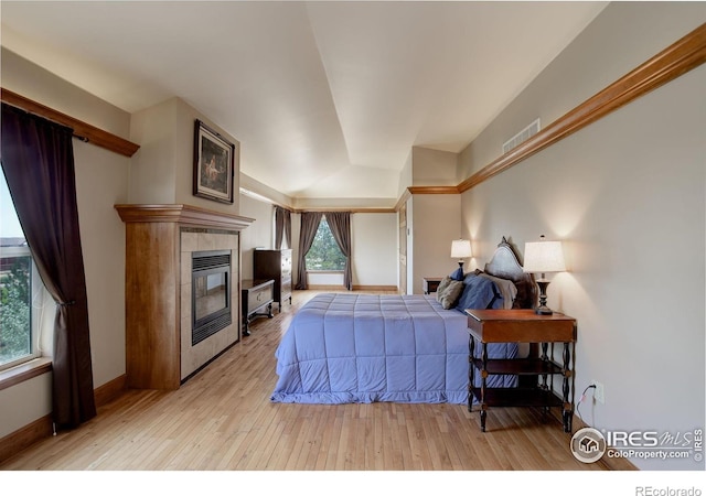 14448 Hanover St, Brighton, CO 80602 - bedroom featuring light wood-style floors and a tile fireplace