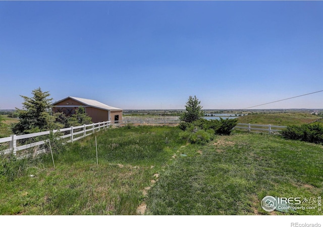 14448 Hanover St, Brighton, CO 80602 - view of yard featuring an outdoor structure, a rural view, and an outbuilding