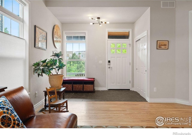 1043 Terrace Cir S, Boulder, CO 80304 - foyer featuring wood finished floors and a chandelier