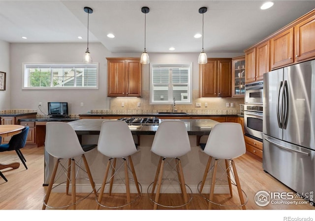 1043 Terrace Cir S, Boulder, CO 80304 - kitchen featuring stainless steel appliances, dark countertops, brown cabinets, backsplash, and recessed lighting