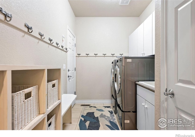1043 Terrace Cir S, Boulder, CO 80304 - laundry room with independent washer and dryer, cabinet space, and light tile patterned floors