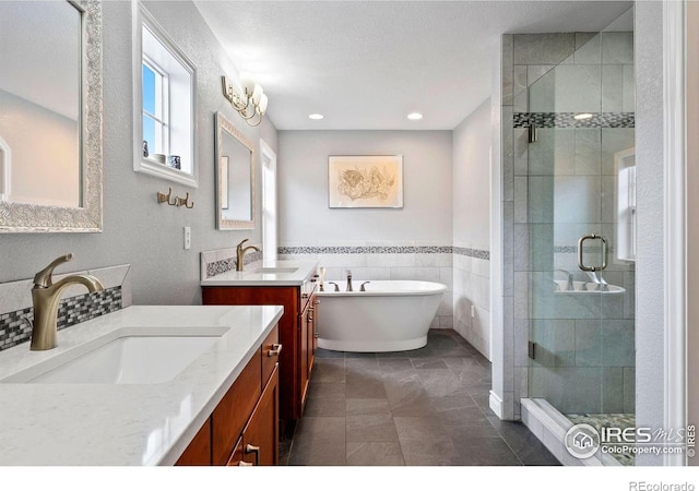 1043 Terrace Cir S, Boulder, CO 80304 - full bath with a shower stall, a freestanding bath, two vanities, recessed lighting, and a wainscoted wall