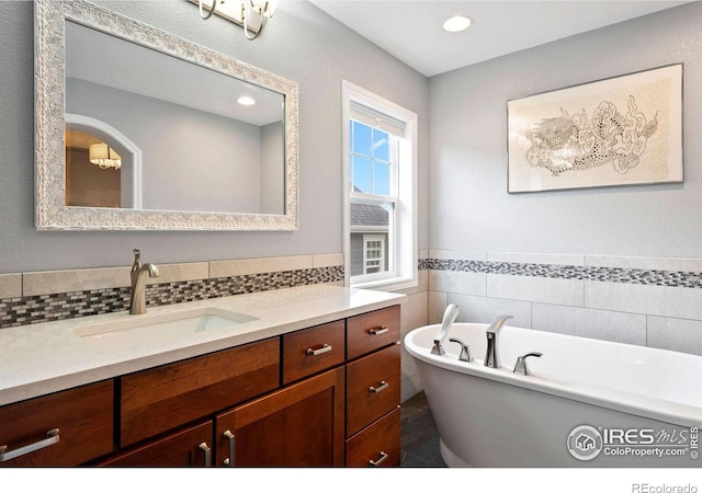 1043 Terrace Cir S, Boulder, CO 80304 - full bathroom with vanity, a freestanding tub, tile walls, and recessed lighting