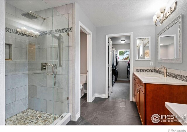 1043 Terrace Cir S, Boulder, CO 80304 - full bath featuring vanity, a shower stall, a spacious closet, and tile patterned flooring