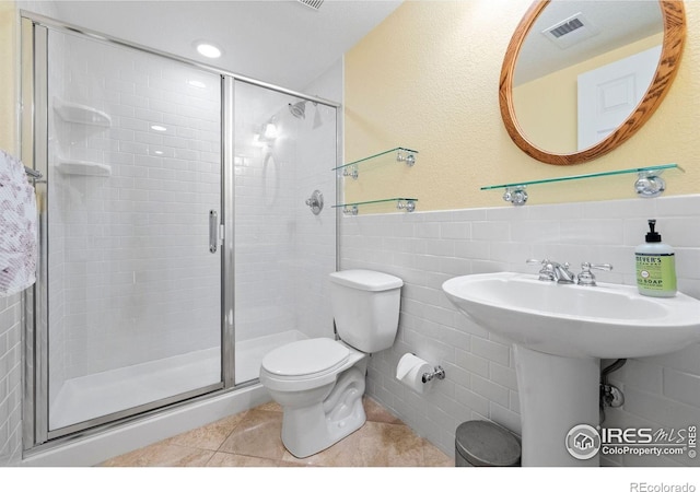 1043 Terrace Cir S, Boulder, CO 80304 - bathroom with tile patterned floors, a stall shower, tile walls, and wainscoting