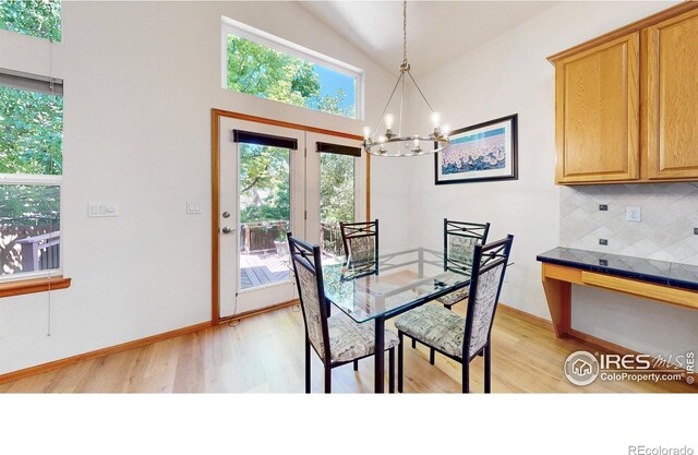 13673 Cook St, Thornton, CO 80602 - dining area with light wood-style flooring, a chandelier, and high vaulted ceiling