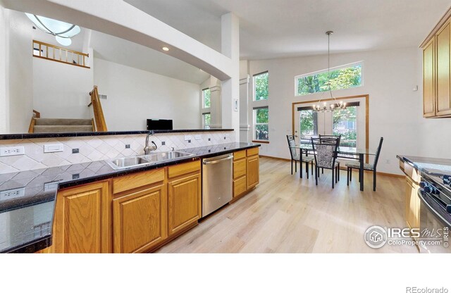13673 Cook St, Thornton, CO 80602 - kitchen with dishwasher, dark countertops, range with gas cooktop, and a chandelier