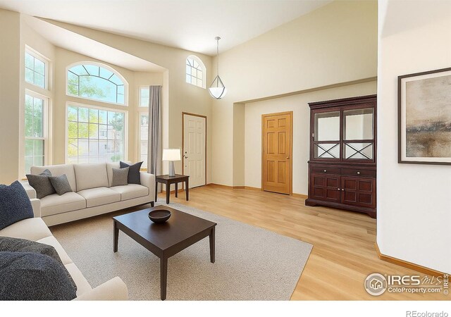 13673 Cook St, Thornton, CO 80602 - living room featuring light wood-style flooring and a high ceiling