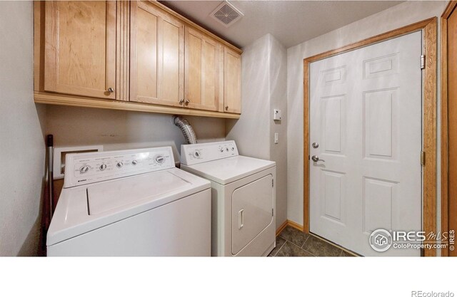 13673 Cook St, Thornton, CO 80602 - laundry area with cabinet space, washer and clothes dryer, and dark tile patterned floors