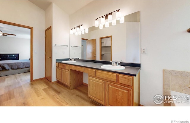 13673 Cook St, Thornton, CO 80602 - bathroom with wood finished floors, double vanity, ensuite bathroom, and ceiling fan