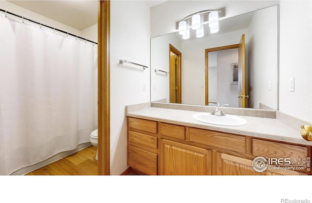 13673 Cook St, Thornton, CO 80602 - bathroom with vanity, wood finished floors, and a shower with shower curtain