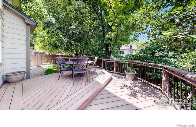13673 Cook St, Thornton, CO 80602 - wooden deck featuring outdoor dining space