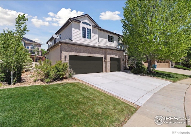 3931 Stonegrass Pt, Broomfield, CO 80023 - traditional-style house featuring an attached garage, brick siding, driveway, and a front lawn