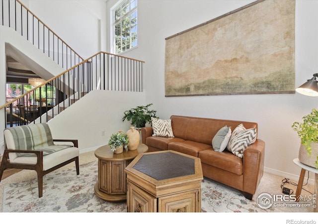 3931 Stonegrass Pt, Broomfield, CO 80023 - living area with light carpet, stairs, and a towering ceiling