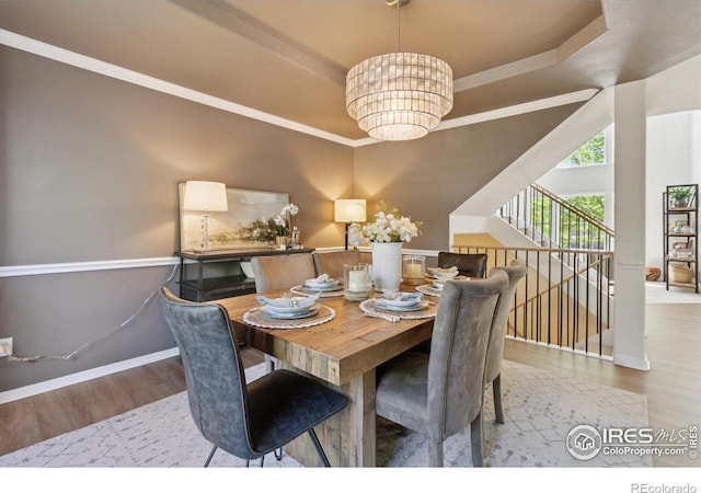 3931 Stonegrass Pt, Broomfield, CO 80023 - dining space with a chandelier, wood finished floors, and a tray ceiling
