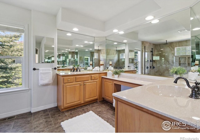 3931 Stonegrass Pt, Broomfield, CO 80023 - bathroom with a shower stall, two vanities, healthy amount of natural light, and recessed lighting
