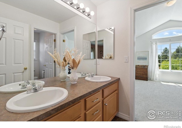 3931 Stonegrass Pt, Broomfield, CO 80023 - bathroom featuring double vanity and vaulted ceiling