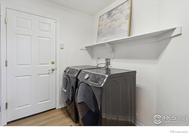 3931 Stonegrass Pt, Broomfield, CO 80023 - laundry area with washer and dryer and light wood finished floors