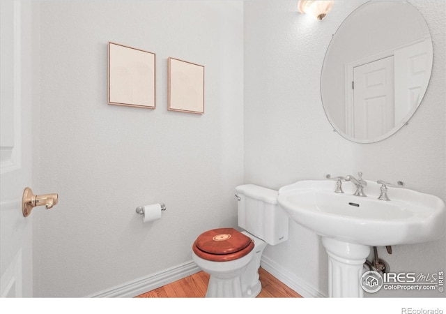 5753 Secrest Ct, Golden, CO 80403 - half bathroom featuring wood finished floors and toilet