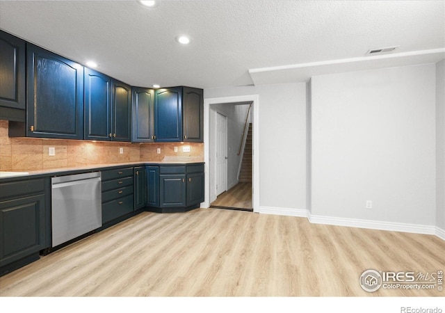 5753 Secrest Ct, Golden, CO 80403 - kitchen featuring stainless steel dishwasher, light wood finished floors, backsplash, light countertops, and a textured ceiling