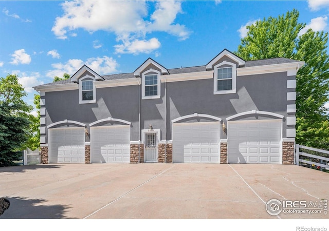 5753 Secrest Ct, Golden, CO 80403 - view of front of home featuring stone siding, stucco siding, and a garage