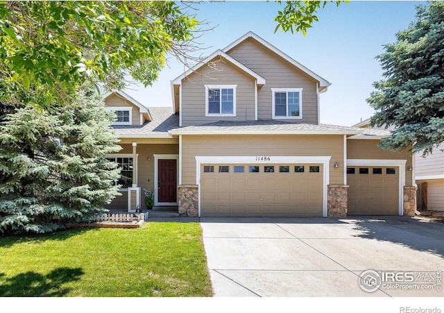 11486 E 119th Pl, Henderson, CO 80640 - view of front of house featuring stone siding, an attached garage, a front lawn, concrete driveway, and a shingled roof