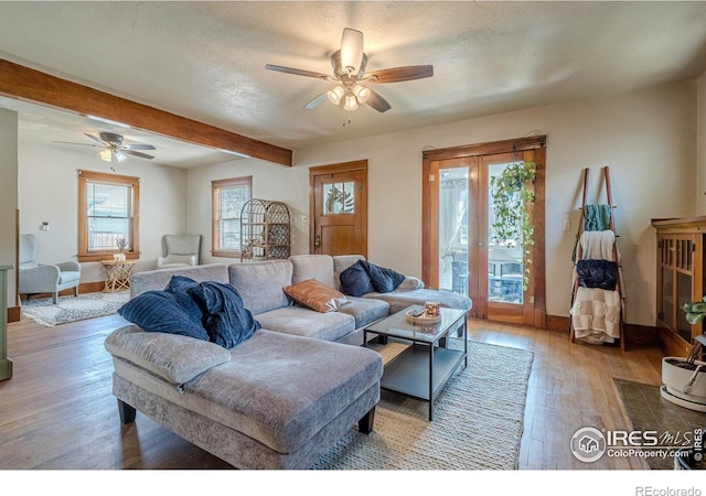 1421 N 7th St, Grand Junction, CO 81501 - living room featuring a ceiling fan, wood finished floors, and beamed ceiling
