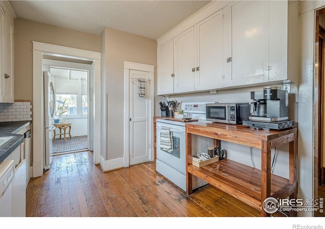 1421 N 7th St, Grand Junction, CO 81501 - kitchen with white appliances, light wood-style flooring, white cabinetry, tasteful backsplash, and wood counters