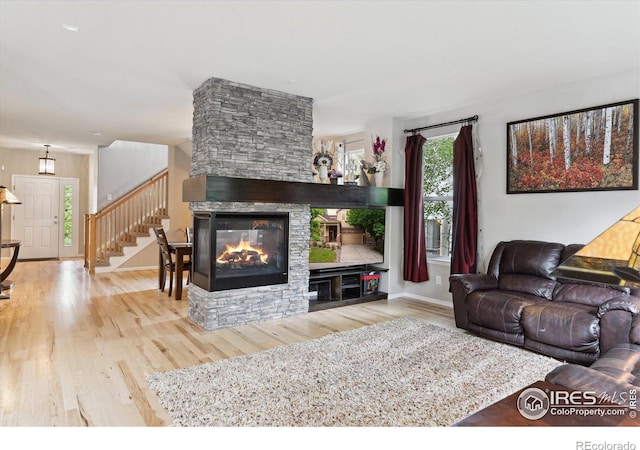 13266 Teller Lake Way, Broomfield, CO 80020 - living room with a fireplace, wood finished floors, and stairway