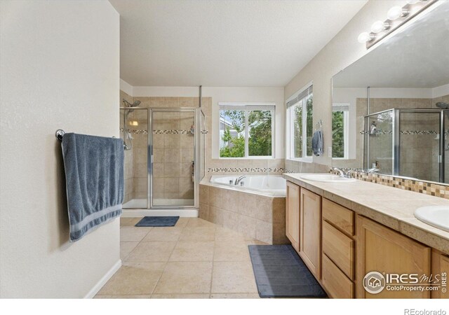 13266 Teller Lake Way, Broomfield, CO 80020 - bathroom featuring a bath, a shower stall, tile patterned flooring, and double vanity