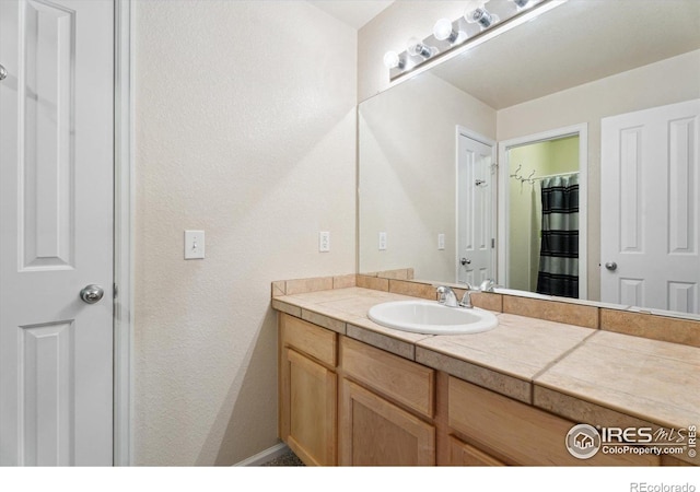 13266 Teller Lake Way, Broomfield, CO 80020 - full bathroom with vanity and a textured wall