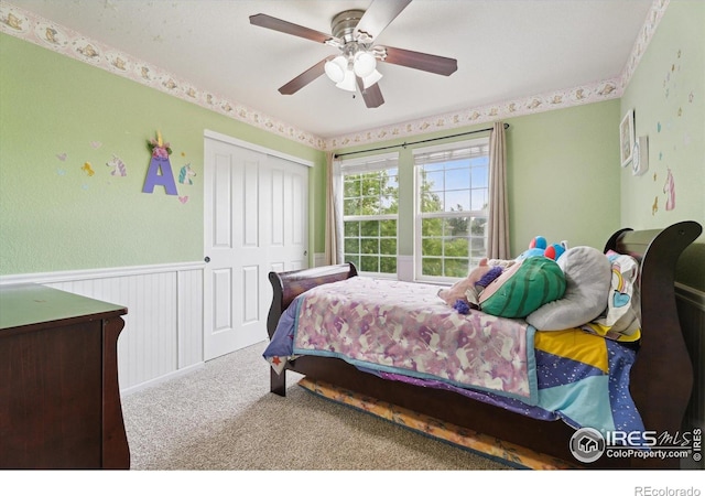 13266 Teller Lake Way, Broomfield, CO 80020 - bedroom featuring a closet, wainscoting, carpet, and ceiling fan