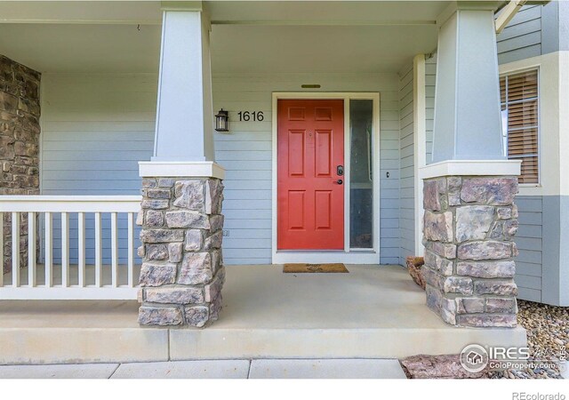 1616 Cedarwood Dr, Longmont, CO 80504 - property entrance featuring covered porch and stone siding