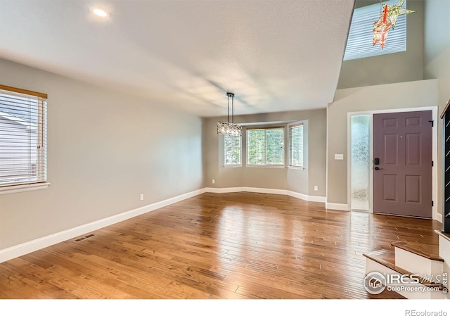 1616 Cedarwood Dr, Longmont, CO 80504 - foyer with a chandelier and light wood-style floors