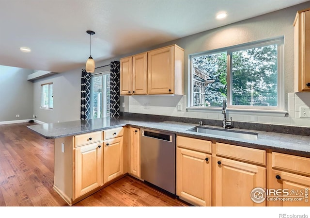 1616 Cedarwood Dr, Longmont, CO 80504 - kitchen with stainless steel dishwasher, light brown cabinets, a peninsula, light wood-type flooring, and dark stone countertops