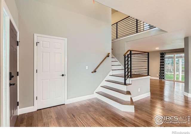 1616 Cedarwood Dr, Longmont, CO 80504 - entrance foyer featuring wood finished floors, stairs, and a towering ceiling