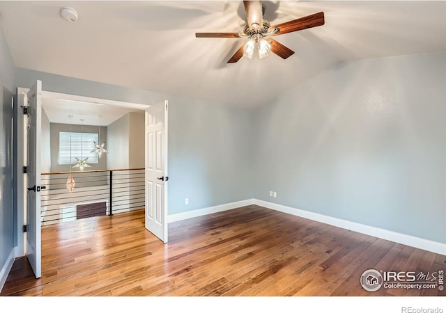 1616 Cedarwood Dr, Longmont, CO 80504 - spare room with ceiling fan, hardwood / wood-style flooring, vaulted ceiling, and a smoke detector