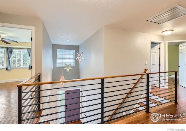 1616 Cedarwood Dr, Longmont, CO 80504 - hall featuring an upstairs landing, attic access, and wood-type flooring