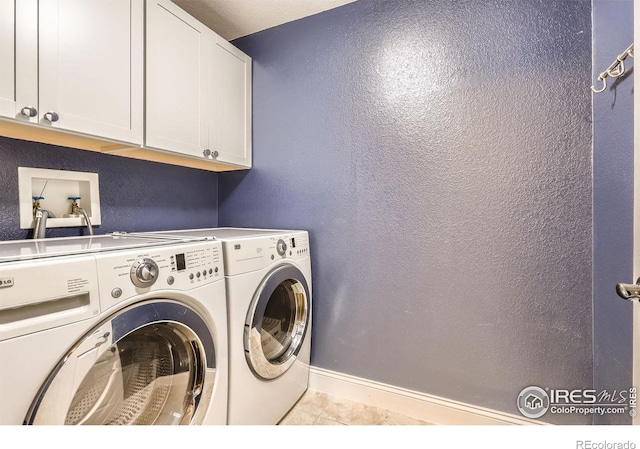 1616 Cedarwood Dr, Longmont, CO 80504 - washroom featuring cabinet space, washer and dryer, tile patterned floors, and a textured wall
