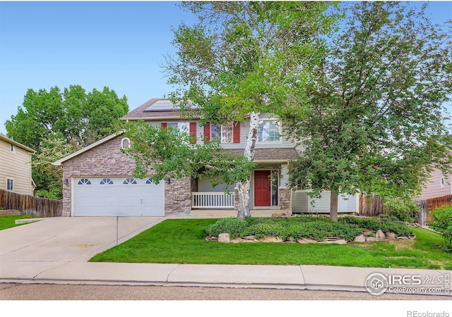 1616 Cedarwood Dr, Longmont, CO 80504 - view of front of house featuring stone siding, concrete driveway, solar panels, and a garage