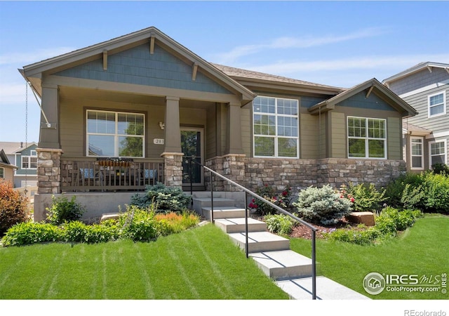 2833 Annelise Way, Fort Collins, CO 80525 - craftsman-style house with a front lawn, stone siding, and covered porch