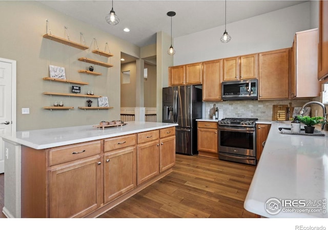 2833 Annelise Way, Fort Collins, CO 80525 - kitchen featuring appliances with stainless steel finishes, dark wood finished floors, backsplash, hanging light fixtures, and light countertops