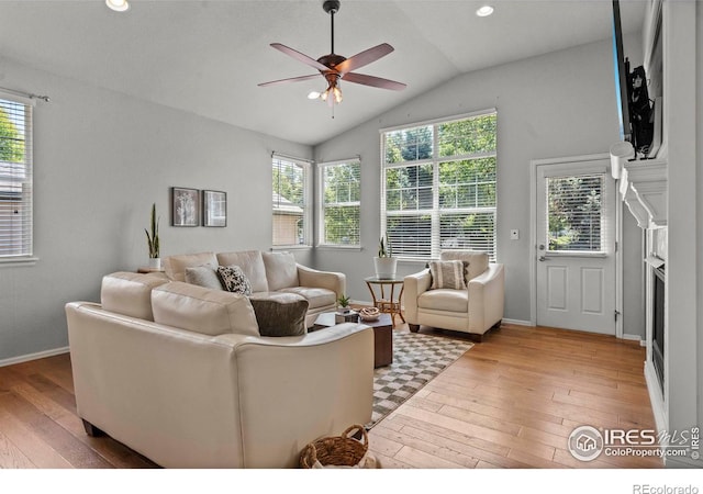 2833 Annelise Way, Fort Collins, CO 80525 - living area featuring light wood-type flooring, a ceiling fan, healthy amount of natural light, lofted ceiling, and a fireplace