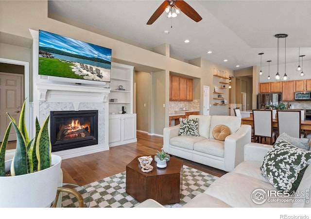 2833 Annelise Way, Fort Collins, CO 80525 - living area featuring a ceiling fan, light wood-type flooring, a fireplace, and recessed lighting